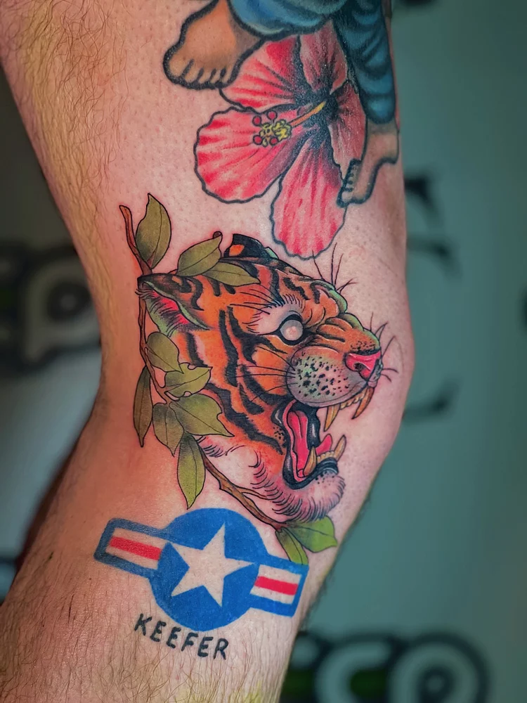 tattoo dallas tiger leaves knee