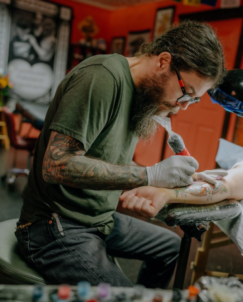 Scott Cooksey tattooing in the shop