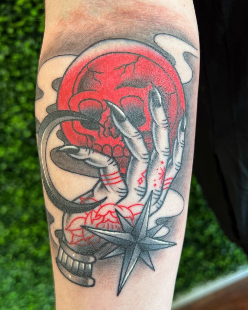 Traditional skull and crystal ball tattoo